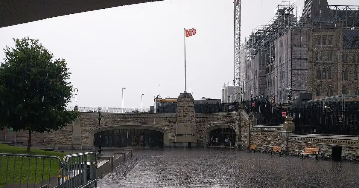 Canadian Parliament buildings under an overcast sky
