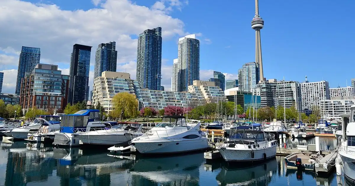Toronto's waterfront skyline and the CN Tower behind a marina full of boats