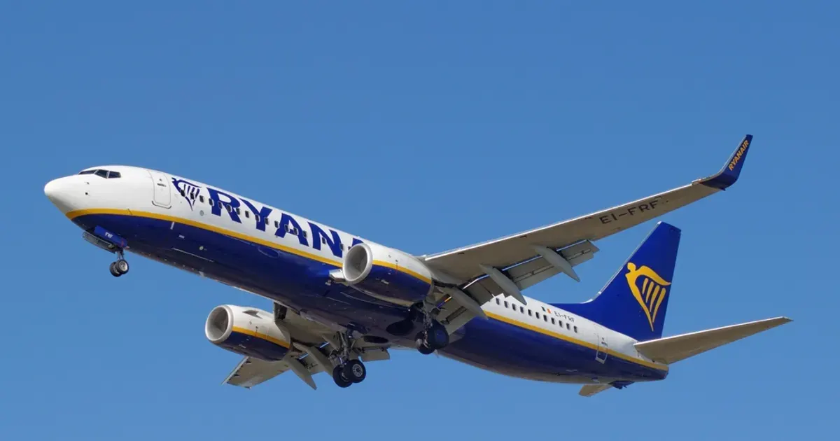 Boeing 737 passenger jet flying against a blue sky