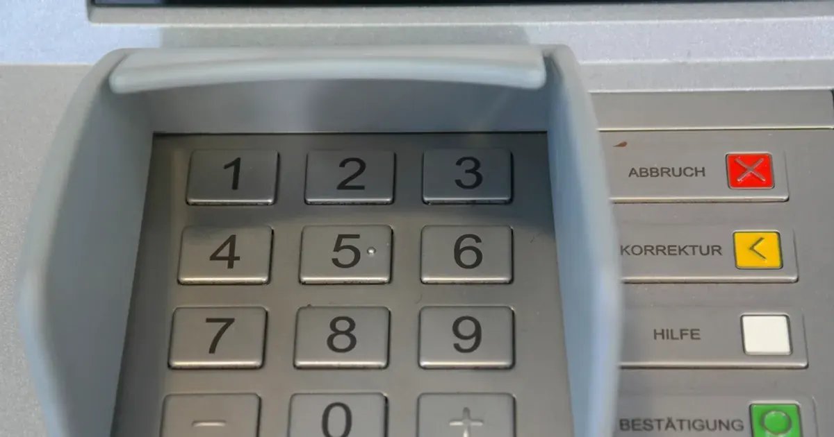 Close-up of a bank machine keypad with number keys and coloured function buttons