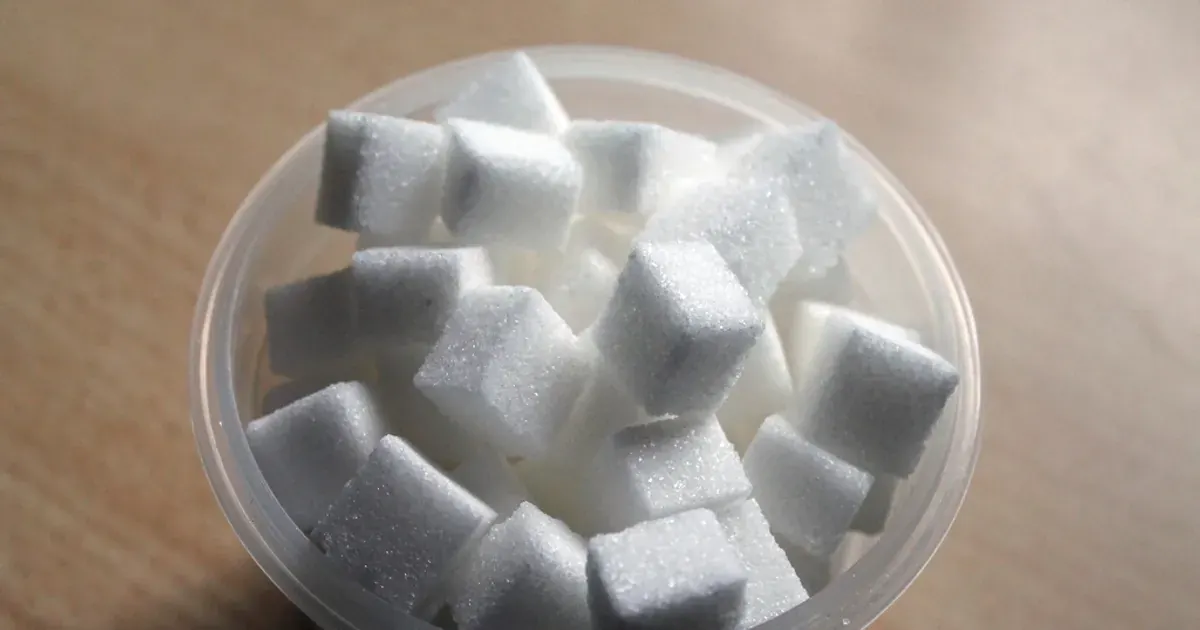A bowl filled with white sugar cubes on a table