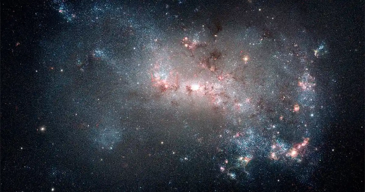 Hubble image of the starburst galaxy NGC 4449, glowing with clusters of young blue stars