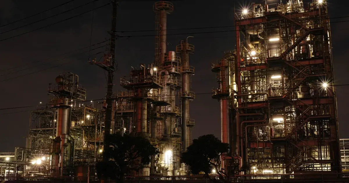Oil refinery towers lit up at night