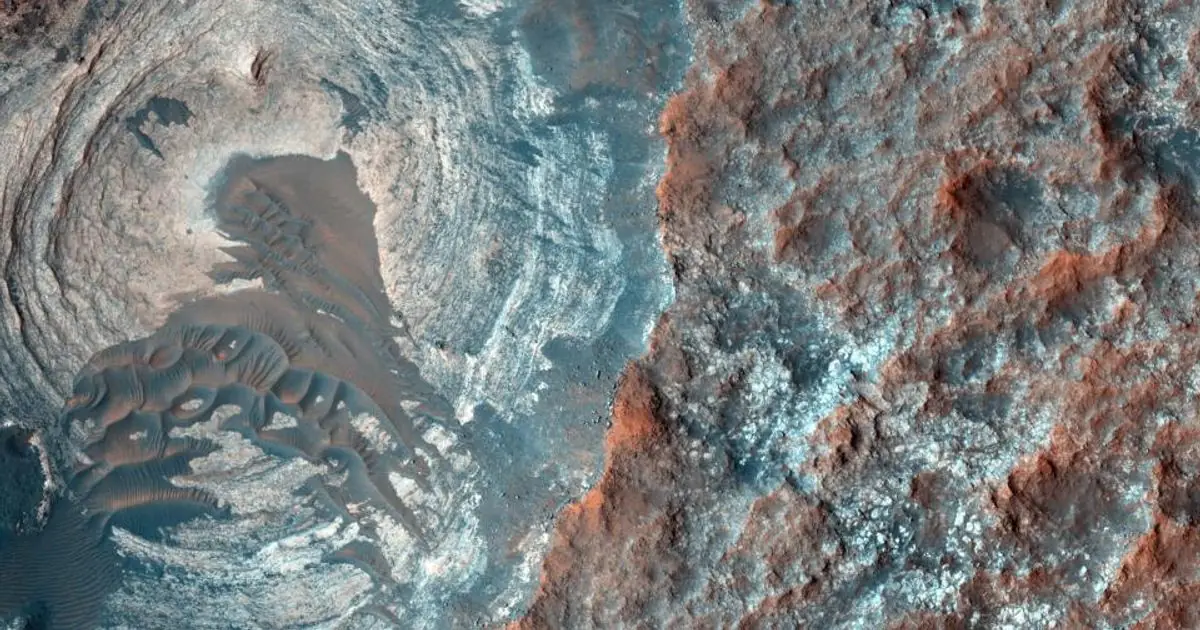 Close-up orbital view of Mars terrain with dunes and rocky reddish ridges