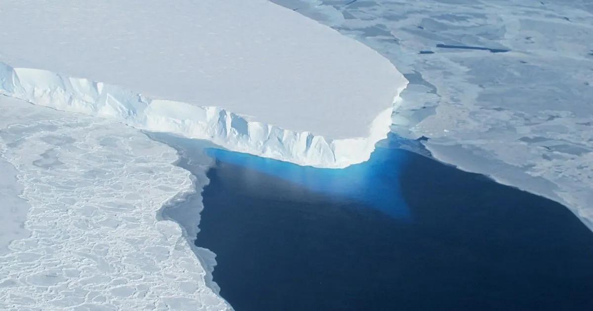 Aerial view of the ice front of Thwaites Glacier in Antarctica above dark blue water