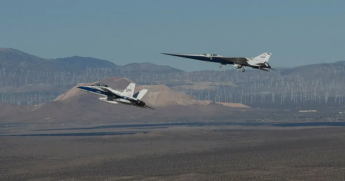 NASA's long, needle-nosed X-59 research jet flying over the Mojave Desert next to a NASA chase plane