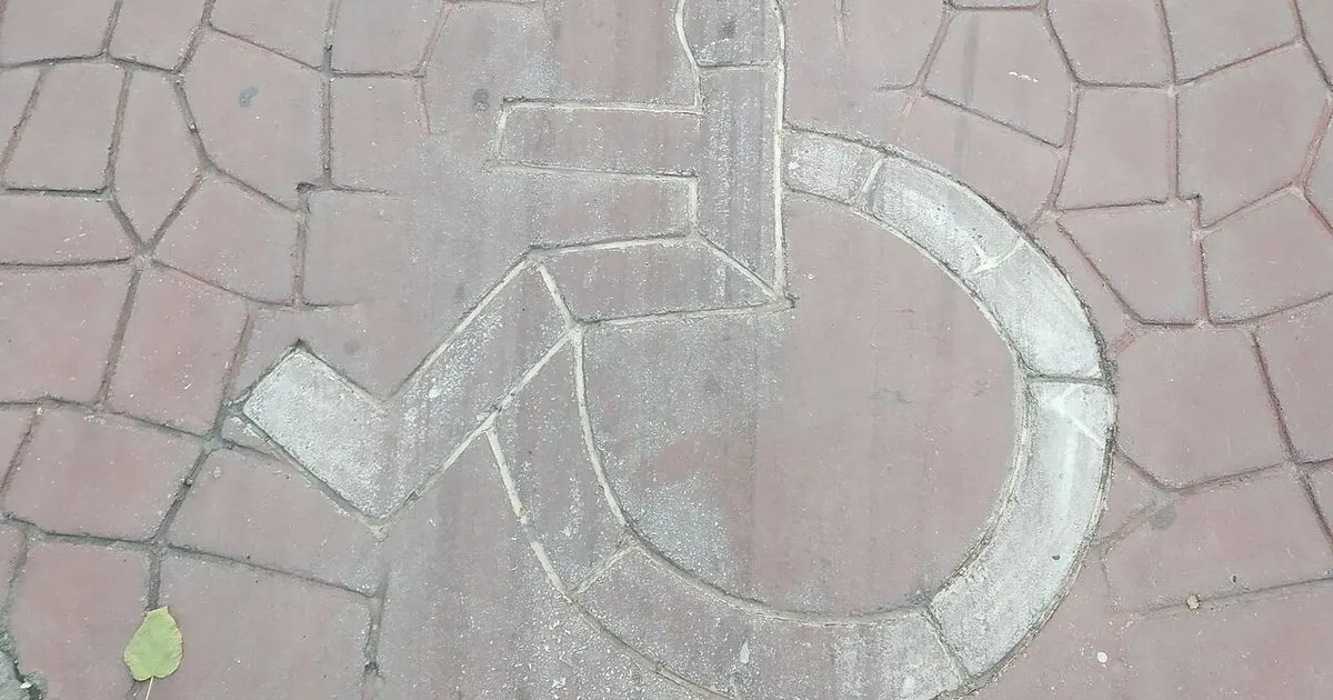Wheelchair accessibility symbols painted on the ground