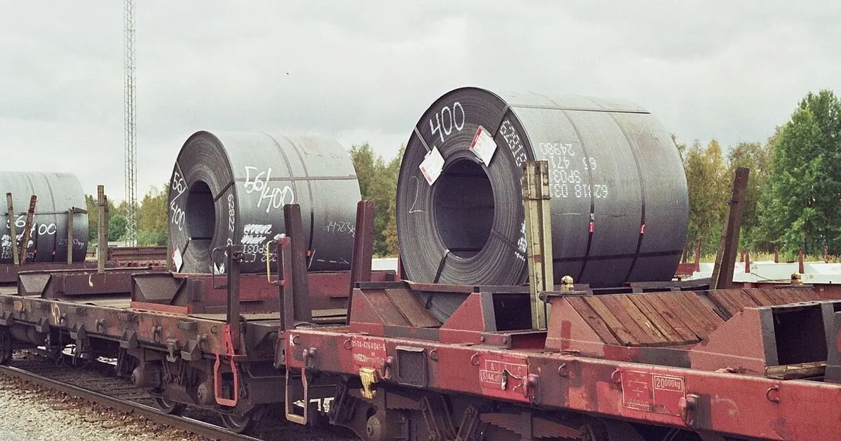 Large rolled steel coils loaded on railway freight wagons