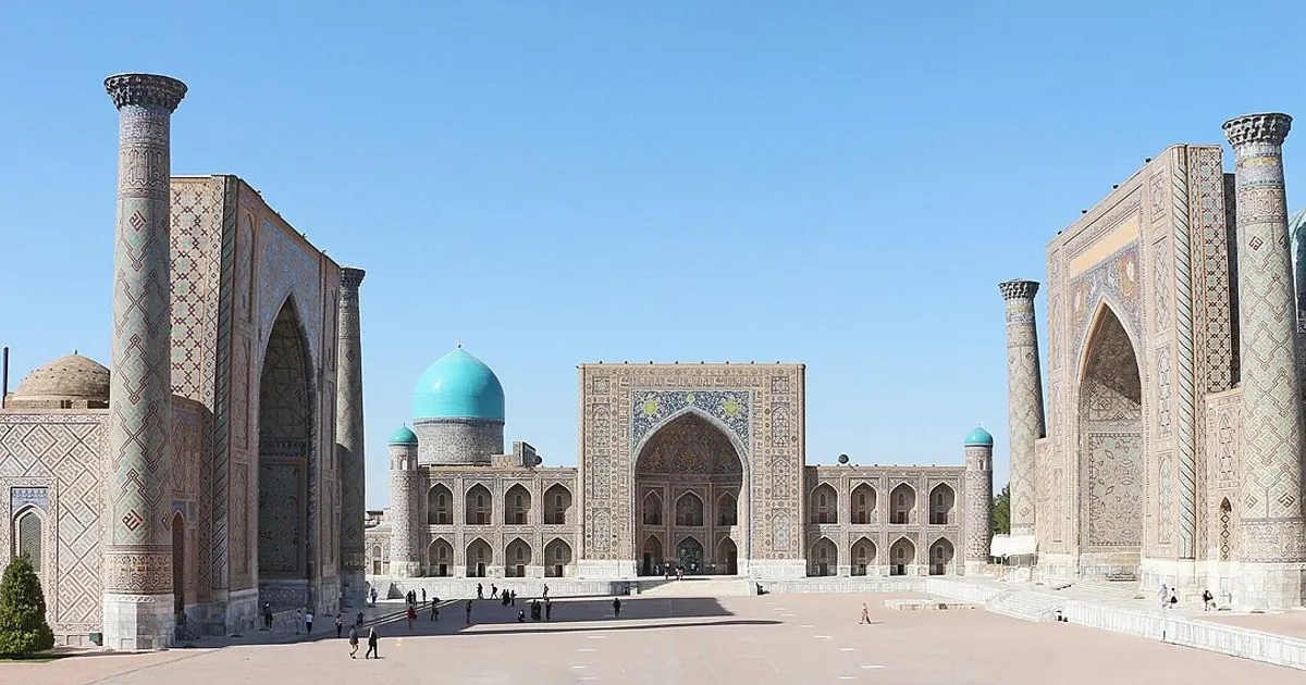 The Registan square in Samarkand, Uzbekistan, with its three tiled madrasas under a blue sky