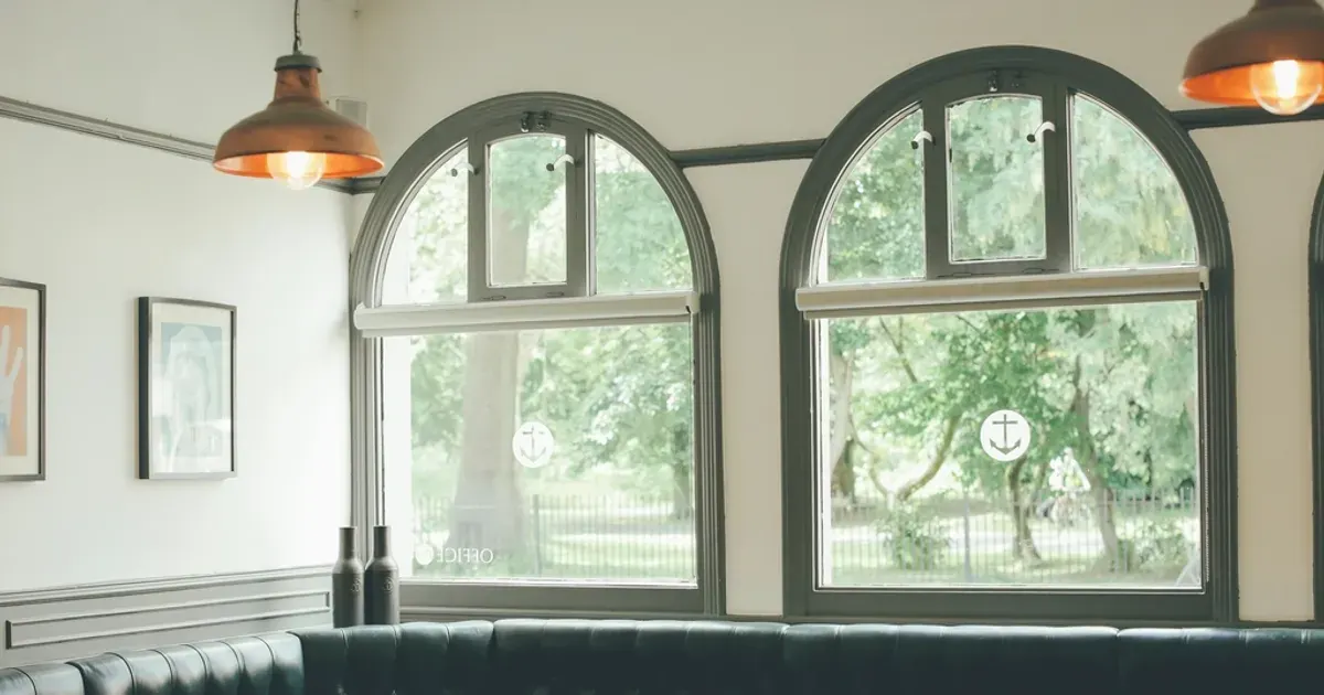 Empty cafe interior with tall arched windows