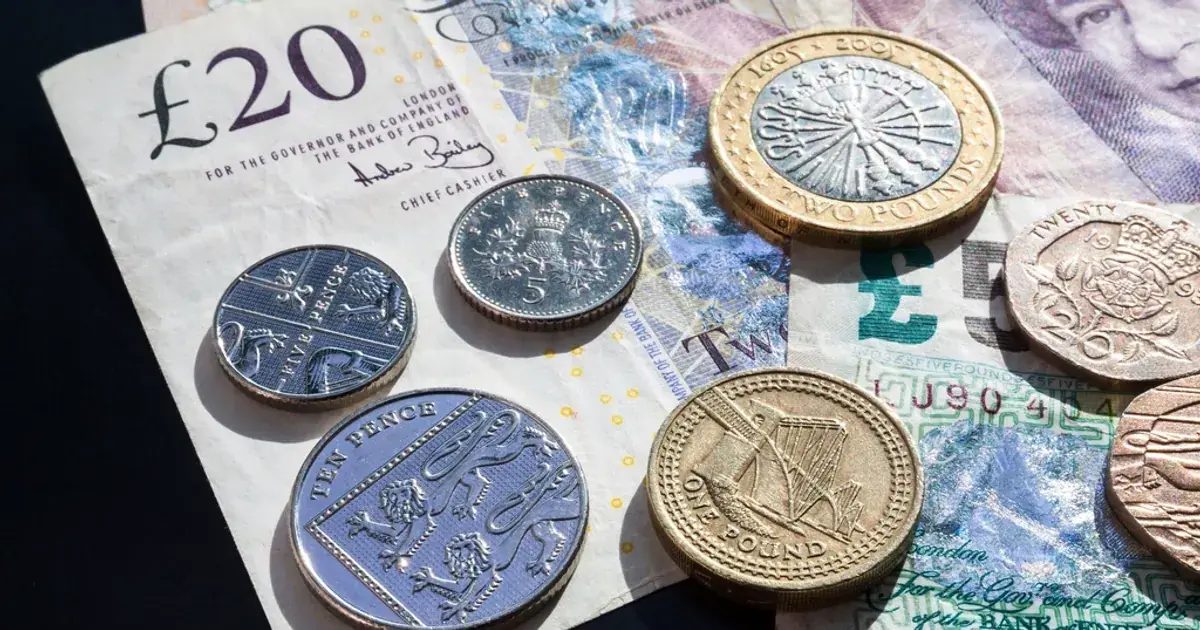 British pound coins and banknotes on a table