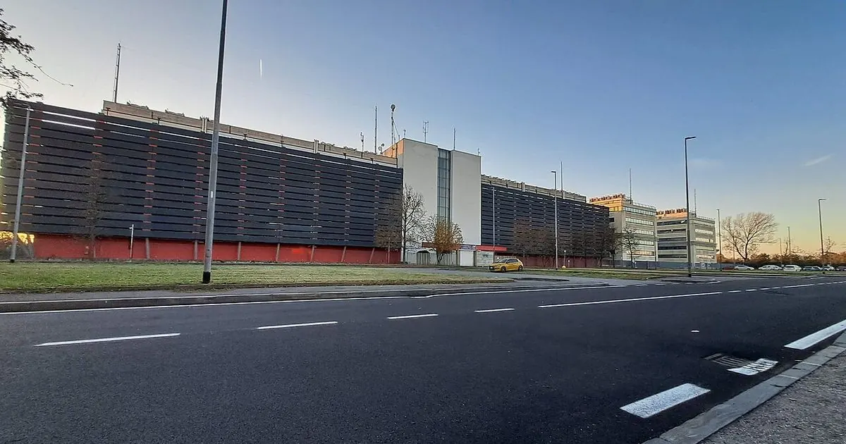 The outside of a large data centre building next to an empty road