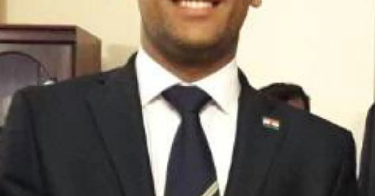 MS Dhoni in formal navy suit with India cricket team pin