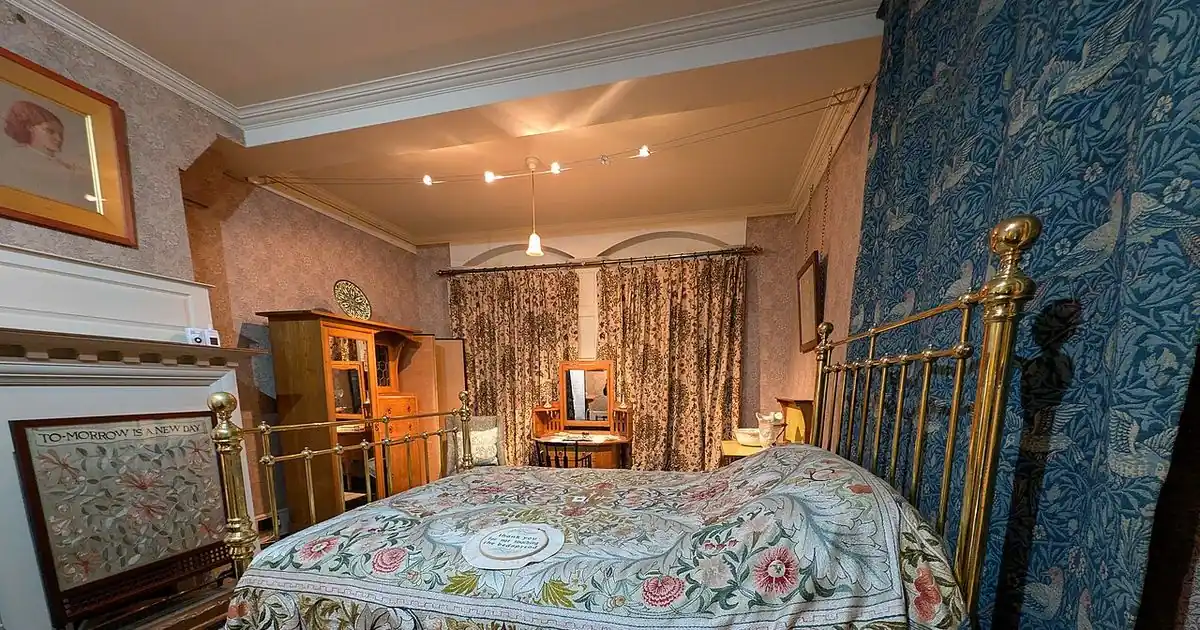 Bright traditional bedroom with wooden furniture and windows