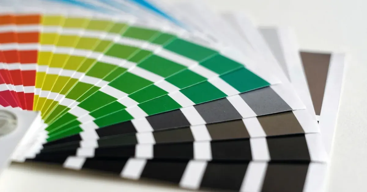 A fanned-out colour swatch guide with shades from red, yellow and green to grey and black