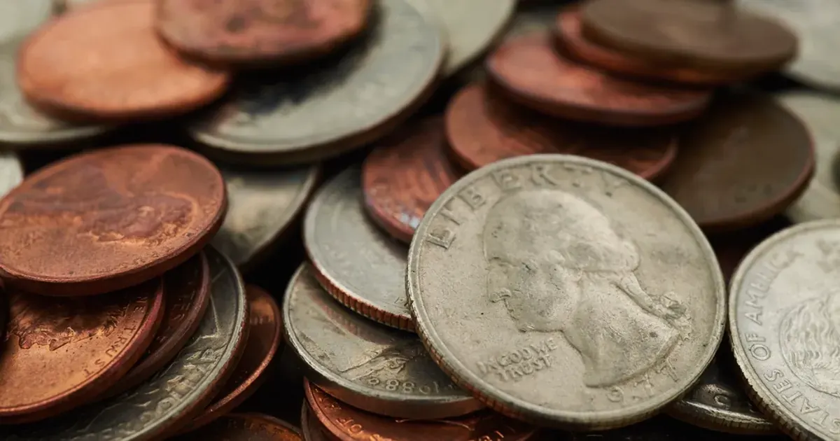 Close-up of a pile of worn US quarters and pennies
