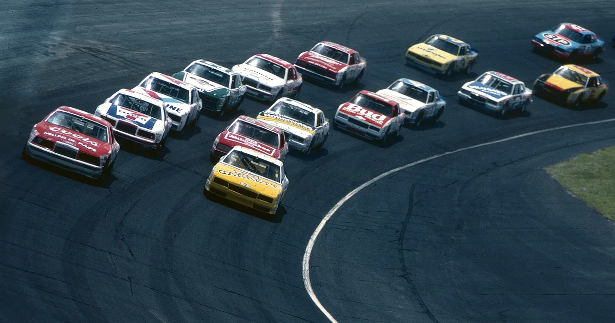 A paved oval racetrack curving into the distance