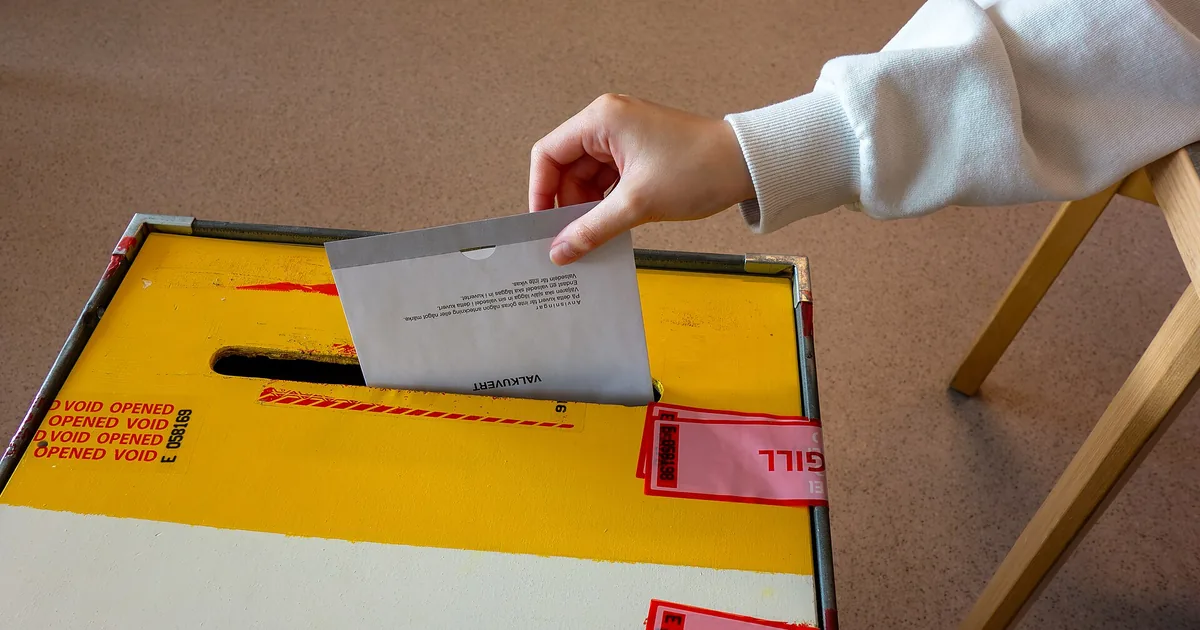 A paper ballot dropped into a ballot box